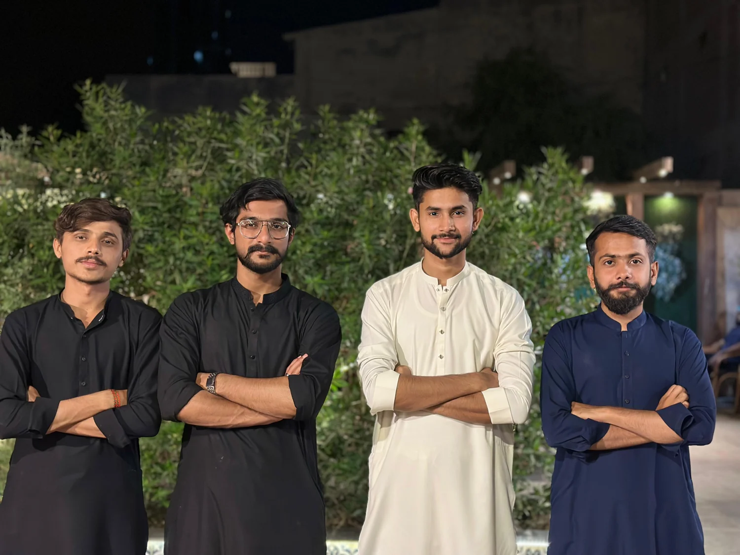 Four friends standing together in the evening