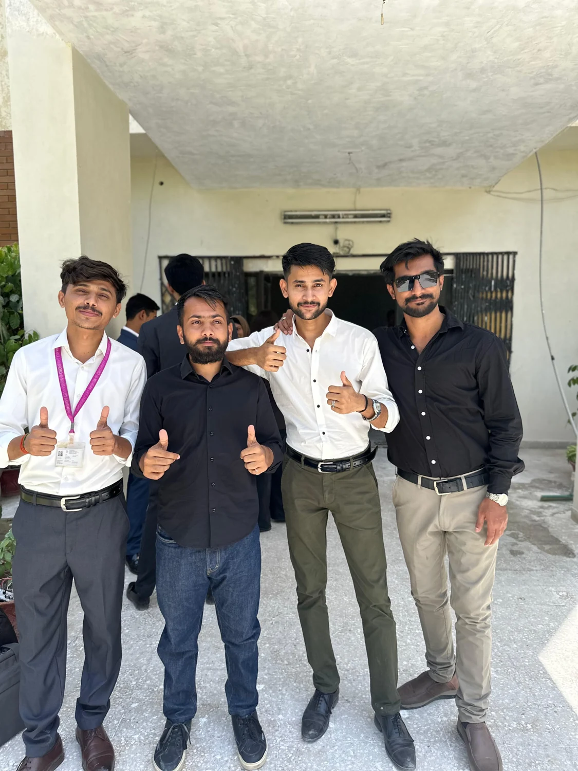 Four friends outside a university building